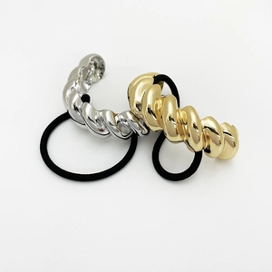 Detail of gold and silver croissant twist metal hair cuffs with elastic bands