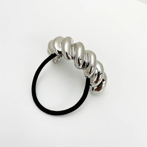 Detailed macro view of black high-elastic hair tie with twisted silver metal ornament