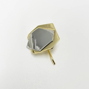 Detail of geometric hair hook with double-layered silver and gold plating