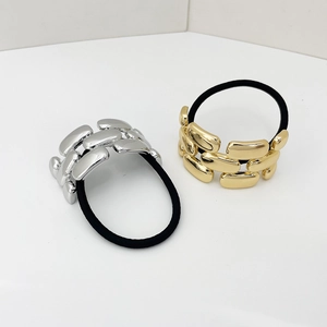 Detailed view of gold and silver chain hair ties with high-elastic bands and polished metal