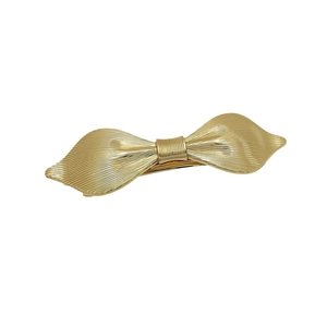 Elegant gold bow-shaped metal hair clip with brushed texture for women's hairstyle