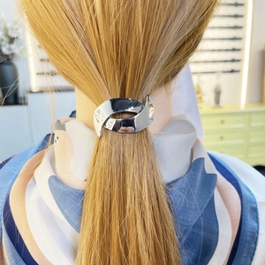 Sleek silver metal ponytail clip for women with minimalist overlapping design on hair