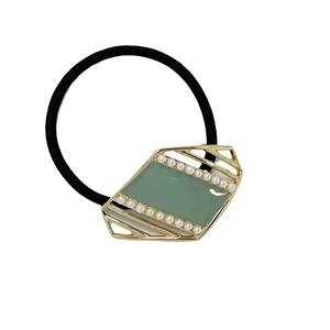 Elegant black hair tie featuring a golden geometric frame with green enamel and pearls