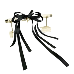 Elegant black ribbon bow hairclip with a white pearl charm and long flowing tassels