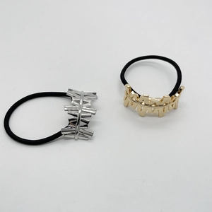 Detail of irregular geometric alloy ponytail holders in gold and silver finishes