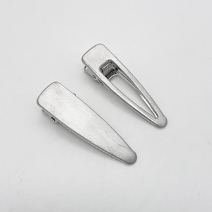 Detail of silver brushed metal hair clips featuring solid and hollow teardrop designs