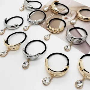 U-shaped alloy ponytail holders with gold and silver finishes and teardrop pendants