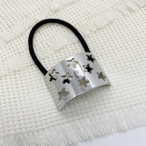 Detail of high-elastic black hair tie with polished silver star-patterned metal buckle