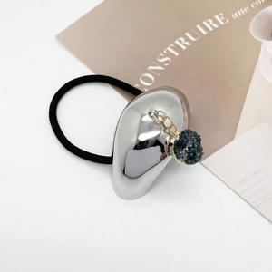 Detail shot of a silver U-shaped alloy accent with dark druzy pendant on a black hair tie