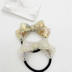 Elegant cellulose acetate bow hair ties in marble and pearlescent white for women