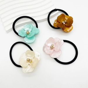 Set of four elegant acetate flower hair ties with pearls and glossy petals in pastel colors