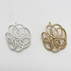 Minimalist geometric metal hair clips in matte gold and silver intertwined circular design