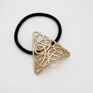 Japanese retro alloy ponytail hook with golden Celtic knot on black elastic hair tie