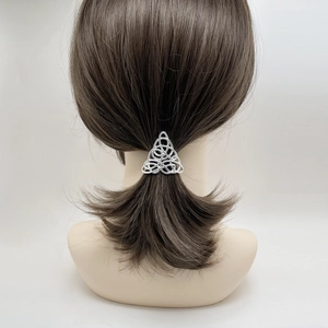 Silver Celtic knot style triangle hair clip securing a ponytail on a model back view