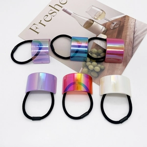 Detail view of 6 colorful U-shaped metallic hair ties and pearl white ponytail holders