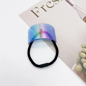 Detail of high-elastic black ponytail holder with metallic iridescent U-shape gradient charm