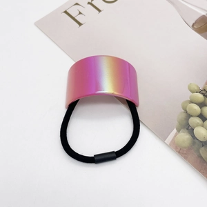 Detailed macro view of colorful gradient metal cuff on thick black elastic hair tie