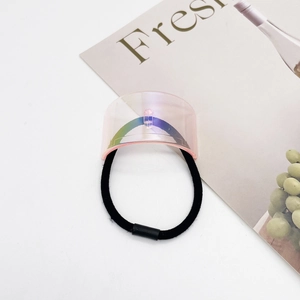 Detail of pink iridescent U-shaped ornament on a high-elastic black minimalist hair tie