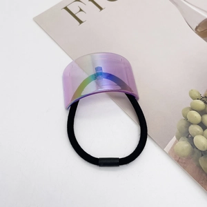 Detail of a purple iridescent acrylic U-shaped hair tie on an aesthetic background