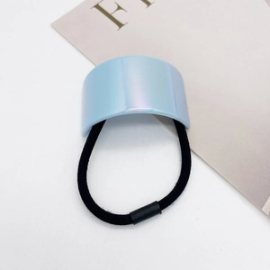 Detail of light blue pearlescent U-shaped charm on high-elastic black hair ring