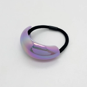 Close-up of minimalist hair tie with iridescent purple UV acrylic ornament on white background