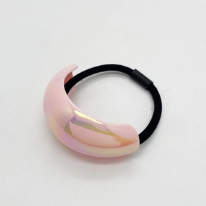 Macro shot of colorful UV acrylic hair tie with metallic iridescent finish on white background