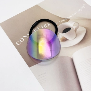 Macro detail of high-elasticity hair tie with a round iridescent acrylic decorative piece