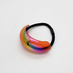 Close-up of crescent acrylic hair tie with iridescent rainbow finish on elastic band