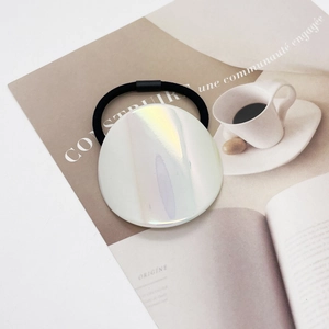 Detail of high-elastic hair tie featuring a holographic circular acrylic decorative piece