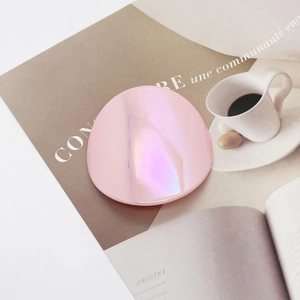 Iridescent pink phone socket grip with pearl finish on a stylish lifestyle background