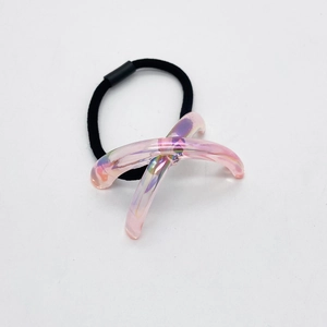 Détail de breloque croisée en acrylique irisé rose sur un élastique à cheveux noir
