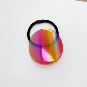 Minimalist elastic hair tie with large colorful iridescent circular charm on white background