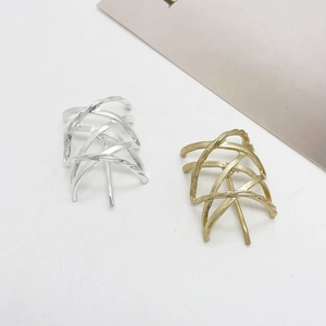 Detailed close-up showing the intertwined layers of gold and silver plated metal ear cuffs