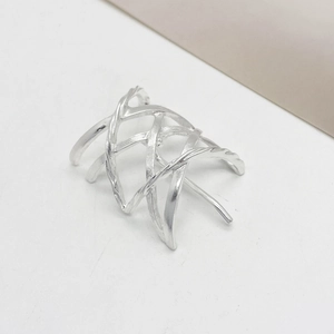 Detail of silver alloy hair clip with hollow cross-layer design and brushed texture finish