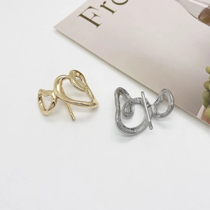 Minimalist irregular wavy gold and silver metal earrings with a polished mirror finish