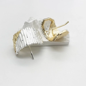 Minimalist gold and silver pleated metal hair clips with modern textured design