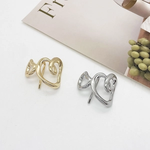 Polished hollow heart-shaped alloy hair clips in gold and silver finish with sleek metal texture