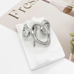 Close-up of a silver hollow heart-shaped hair hook with a polished metallic finish