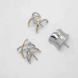 Close-up of minimalist metal hair clips in gold and silver finish with rhinestones