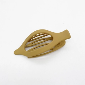 Detailed close-up of khaki matte ponytail hair clip with sleek hollow leaf design