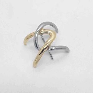 Detail of two-tone intertwining abstract curved lines hair clip with gold and silver finish