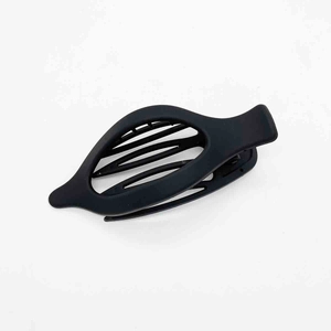 Close-up of matte black fish-shaped hair clip with multi-row inner teeth detail
