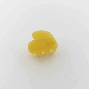 Detail view of a yellow heart acetate hair claw with France Handmade gold lettering