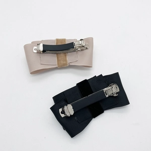 Detailed back view of the rhinestone bow hair clip with silver metal spring fastener