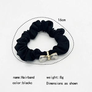 Elegant black satin hair scrunchie with crystal butterfly bow detail and gold clasp