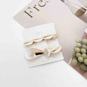 Close-up of summer seashell and starfish hair clips set on elegant display card