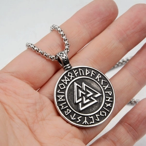 Detail of the vintage silver Valknut pendant necklace with Nordic runes and steel bead chain