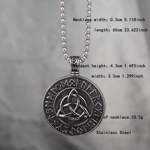 Detailed macro view of stainless steel Celtic Triquetra pendant with runic alphabet engravings
