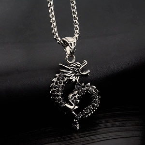 Macro shot of silver dragon pendant necklace with sparkling black zircon stones