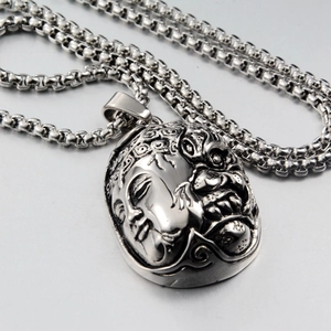 Macro shot of silver dual-faced deity pendant with thick stainless steel round box chain
